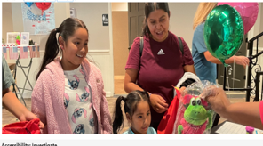 Students and parents at resource table to receive reading information